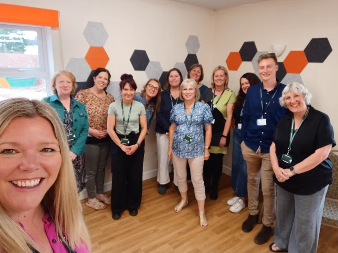 Group selfie of Occupational Therapists and Social Workers, stood together, at a recognition event organised by Devon County Council, Integrated Adult Social Care and Health.