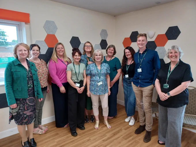 Group of Occupational Therapists and Social Workers , stood together, at a recognition event organised by Devon County Council, Integrated Adult Social Care and Health.