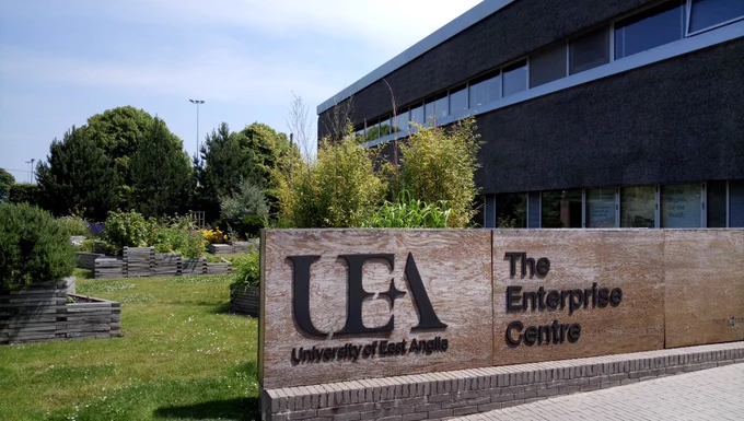 Gardens and entrance sign behind The Enterprise Centre