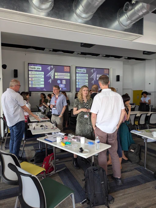 A crowd of people having conversations with each other
