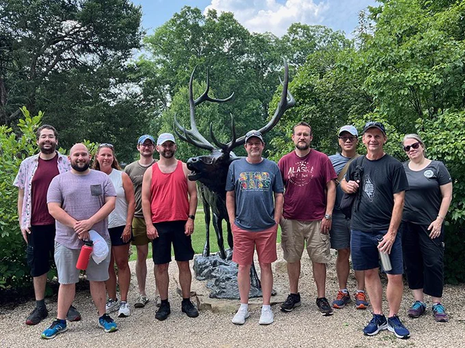 Net Tango Team with an Elk statue in front of the Salato Center