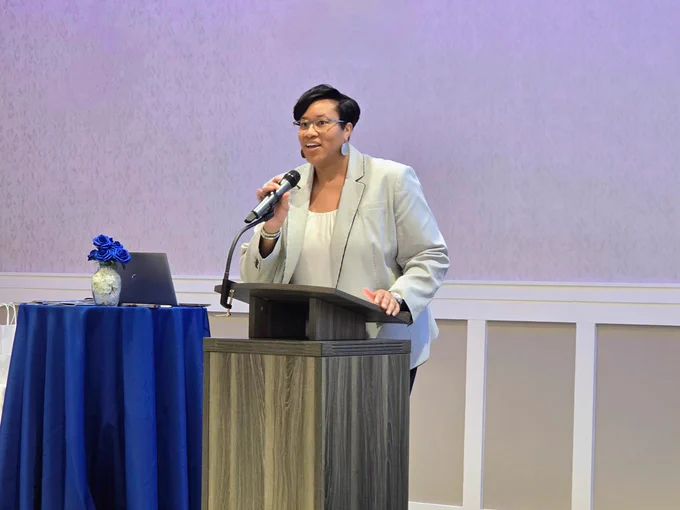 A woman speaking at a podium