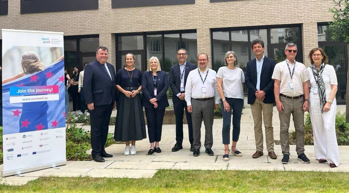 Rectors and university leadership of the 7th EUniWell Rectors' Assembly stand outside a building of Nantes Université. 