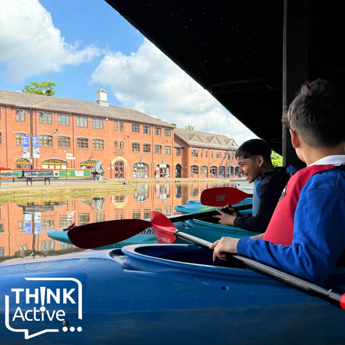 [Two boys laugh together in kayaks. above the Think Active logo]