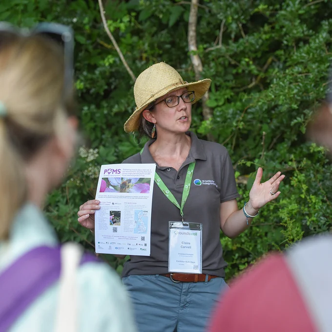 Dr Claire Carvell holding a POMS leaflet