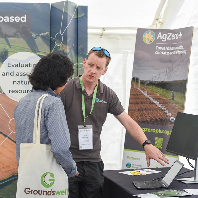 Dr John Redhead discusses digital tools with a visitor to a stand