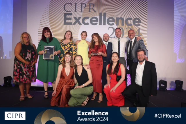 Photo of one of the hub leads and the BPS communications team collecting the award for winning the CIPR Not-For-Profit Campaign. Dark blue with gold circles graphic design along the bottom contains CIPR logo, Excellence Awards 2024, #CIPRexcel 