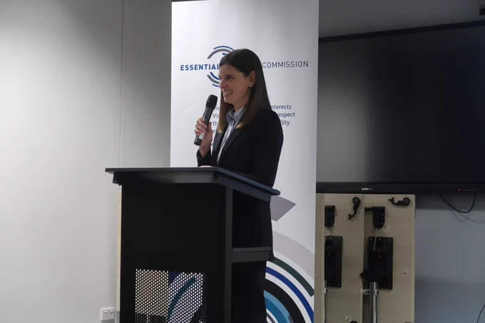 Outgoing Essential Services Commission Chairperson Kate Symons smiling and delivering her farewell speech to staff. 