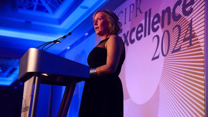 CIPR President Rachael Clamp on stage behind a lectern giving the opening speech at the 2024 CIPR Excellence Awards.