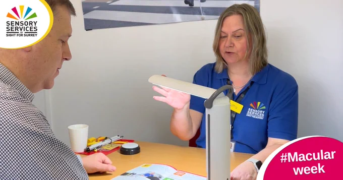 Eye Clinic Liaison Officer Cathy demonstrates a task lamp to a service user. Below right text reads #Macular week in a bubble. Top left is our charity's logo.