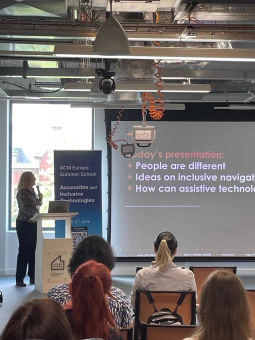 Dr Colette Jeffrey on the stage, gave a very interesting talk about wayfinding and challenges faced by disabled people when navigating environments. 