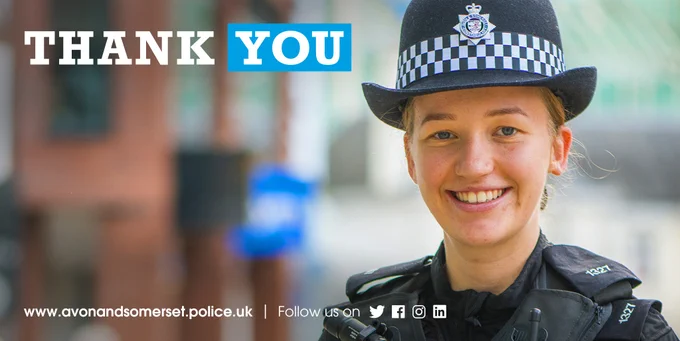 A uniformed police officer smiling at the camera and the words "thank you".