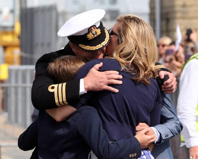 UK Service man hugging a woman and child photo