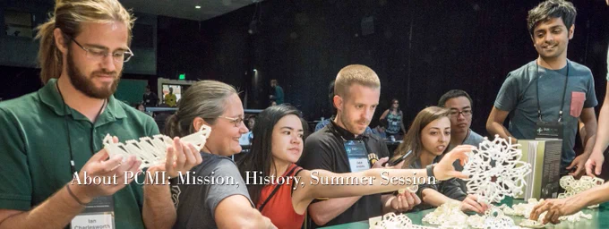 In this photo from a former event, seven participants of varying ages, races and genders work together and in parallel with white geometric manipulative materials that fit together into three-dimensional shapes.