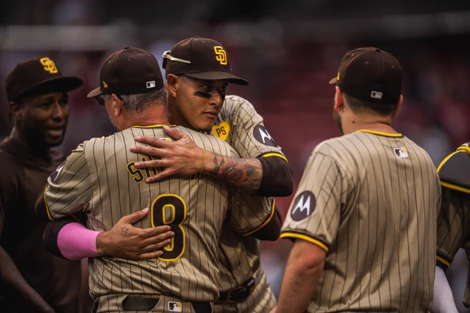 Photo of Manny Machado hugging Mike Shildt after today's win in Boston. Both are wearing the Padres sand road pinstripes uniform.