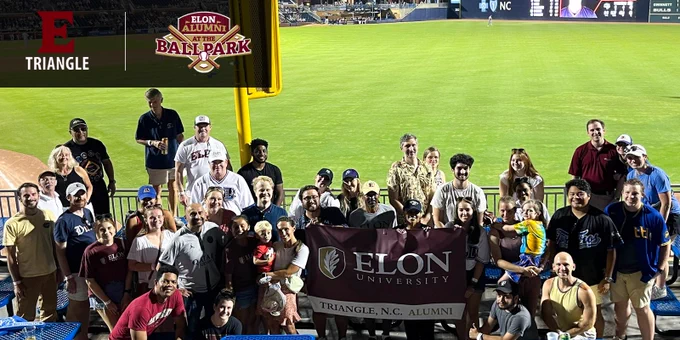 Elon Triangle and Elon Alumni at the Ballpark logos over group of Elon alumni with Durham Bulls baseball in background holding Elon Triangle, N.C. alumni banner. 