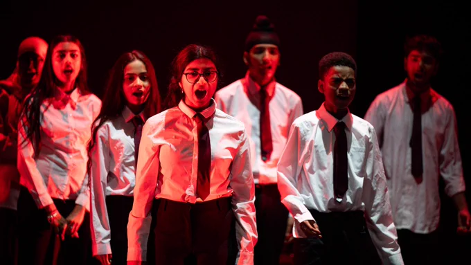 Young people on stage shouting
