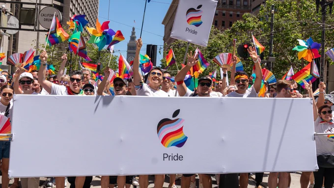 Team members march with an Apple Pride banner during the San Francisco Pride Parade.