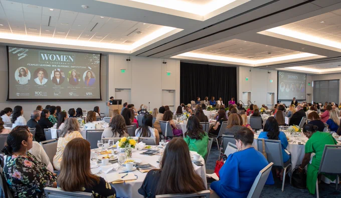 A wide shot of event attendees in the room.