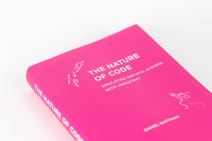 Close up on the very pink cover of Nature of Code book