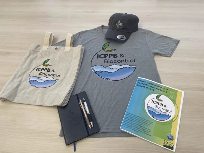 An assortment of merchandise from the ICPPB & Biocontrol 2024 conference.