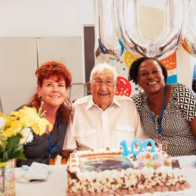 Charlie Hatfield with Age UK Ealing's Wellbeing Day Centre Managers Jan (left) and Carolyn (right) at Charlie's 100th birthday party