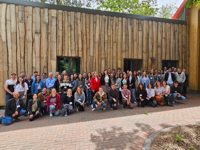 Conference delegates poising for photo outside new building