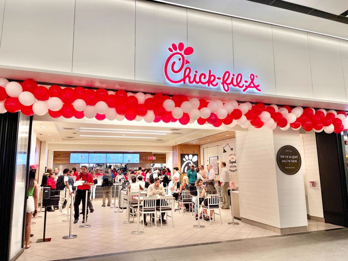 Chick-fil-A's storefront at the LIRR Concourse at Penn Station, filled with customers and employees inside.