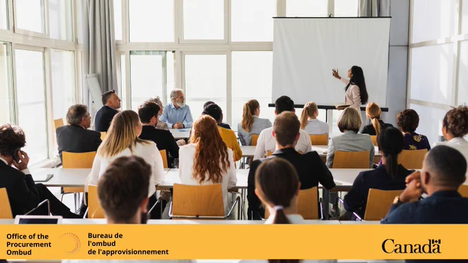 A woman gives a presentation to a group of people.