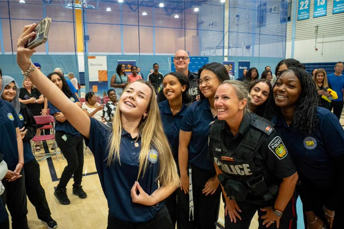 YIPI students take a selfie with a police officer.