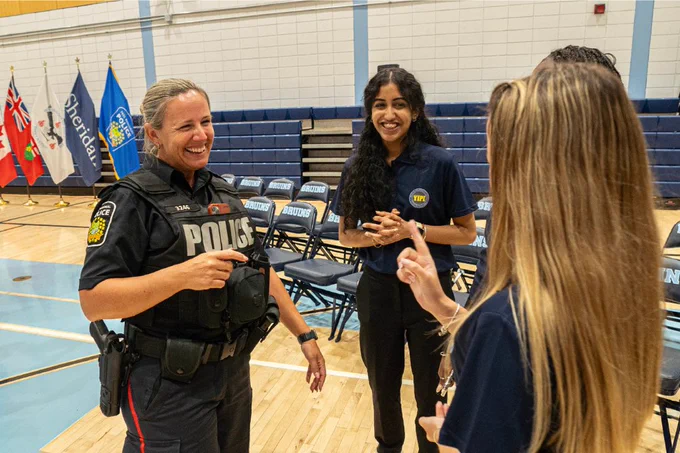 YIPI students speak with a police officer.