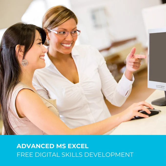 Smiling woman points to a computer screen while another smiling woman navigates the computer.