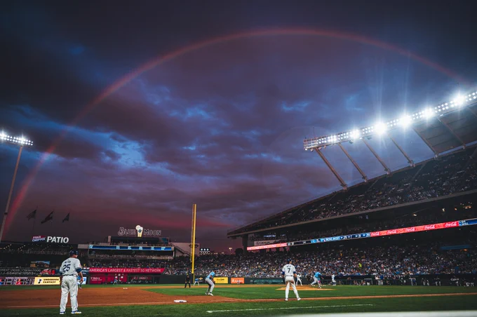 A photo of Kauffman Stadium as a rainbow arches across the sky behind it. (Photo by Amy Kontras/Kansas City Royals)