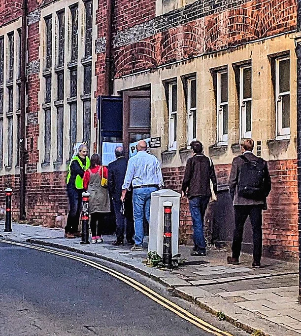 A queue of people outside a polling station