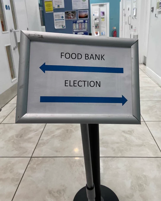 A sign with two arrows on. One arrow points left and is labelled 'food bank'. The second arrow points right and is labelled 'election'.