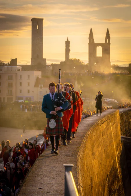 University of St Andrews piper leads torchlit procession