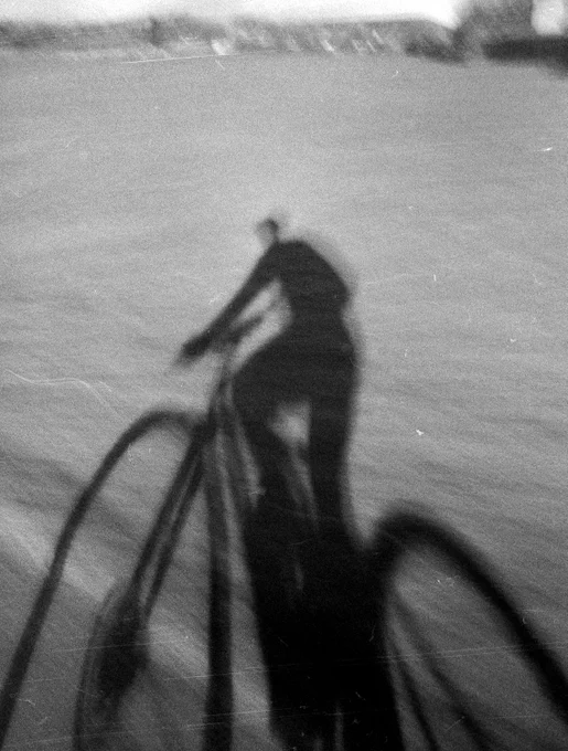Half frame black and white shadow selfie photograph whilst cycling