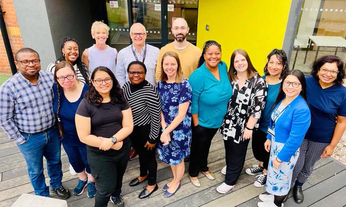 Group of researchers smiling outside coventry building