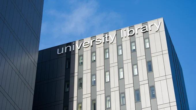 Image of the University Library sign at the top of the Library building.