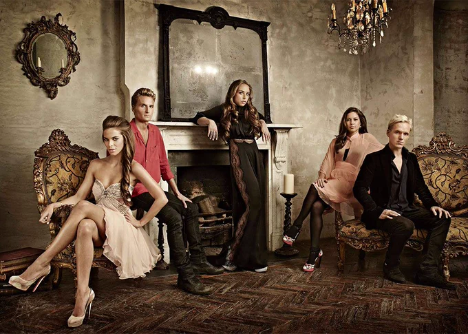 A group photo from season 2 of Made In Chelsea. On the left sitting down is Victoria Baker-Harber next to her is Ollie Proudlock. In the middle is Chloe Green, standing up leaning on a fireplace. On the right is Louise Thompson and next to her is Jamie Laing both sitting down.