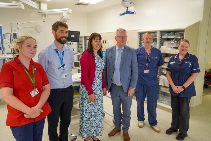 A phot of six people standing on an emergency department ward at Ulster Hospital. From left to right the people are: Janet McKibbin, ED Sister, Marc Neil, Director of Unscheduled Care, Roisin Coulter, Chief Executive of South Eastern Trust, Health Minister Mike Nesbitt, Dr Andrew Dobbin, ED Consultant and Jenny Nicholson, Lead Nurse ED 

