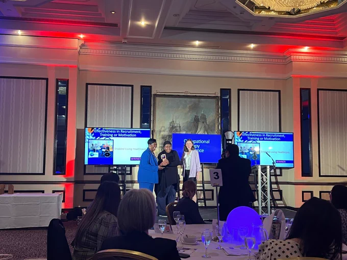 Aqua and Fiona accepting the award on stage.
