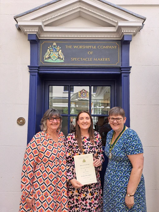 Erica, with her mum Wendy and Helen the Clerk after her Freedom Ceremony. Erica is holding her Freedom certificate and Helen is wearing her Clerk's badge. All three are wearing bright summer dresses and smiling.