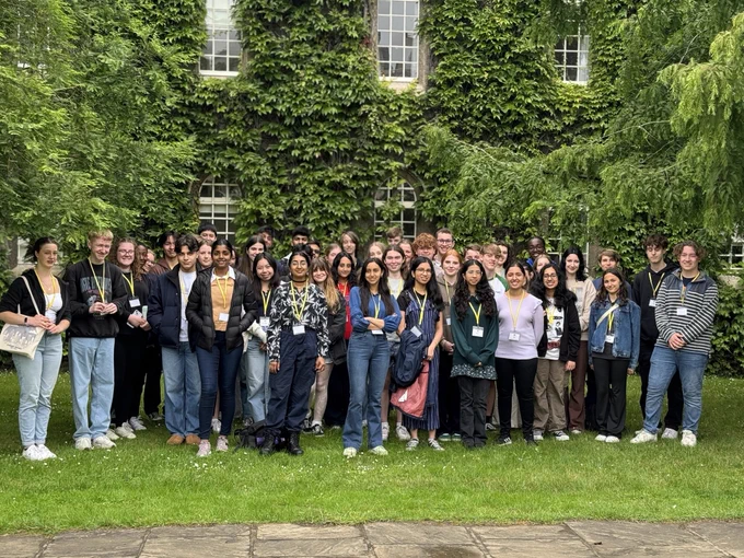 Forty-eight Year 12 students from across England and Wales stand in front of the ivy-covered New Court at St John's College, Cambridge, during their two-day Natural Sciences residential course.