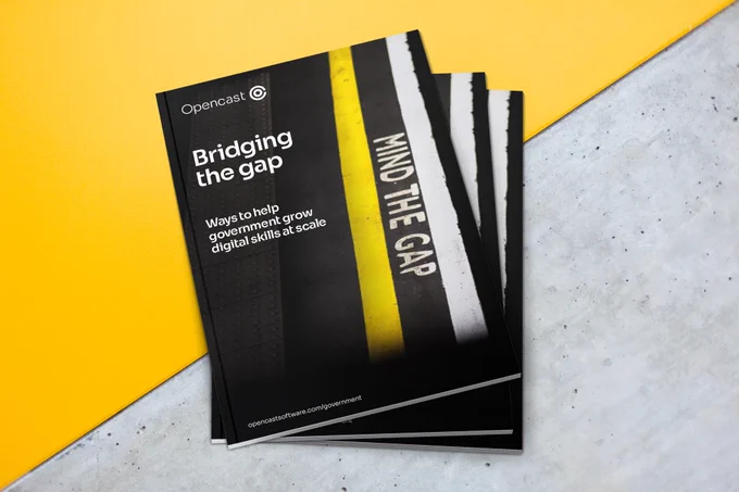 Stack of 'Bridging the gap' publications sits on yellow and grey table.