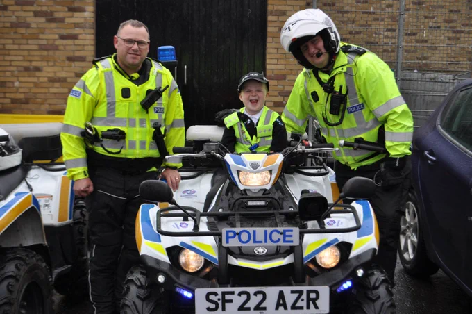 Young person with officers and quad bike