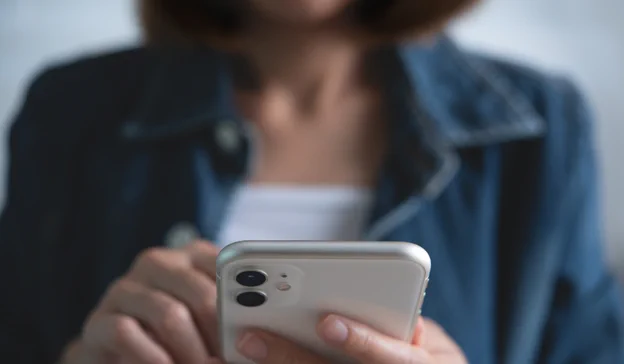 Close up photo of a woman on her phone.