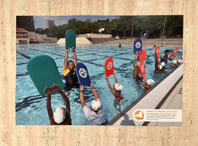 Photo of a group of kids at a swimming lesson, part of the New York State Parks 100, “We’ll See You Out There” centennial exhibit on view in the State Street Tunnel at the New York State Capitol.