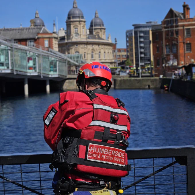 A Firefighter looking into the water 