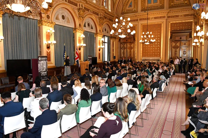 The Srebrenica Memorial Day Event in London, to remember the Srebrenica Genocide. A large room full of people are seated and facing the stage.